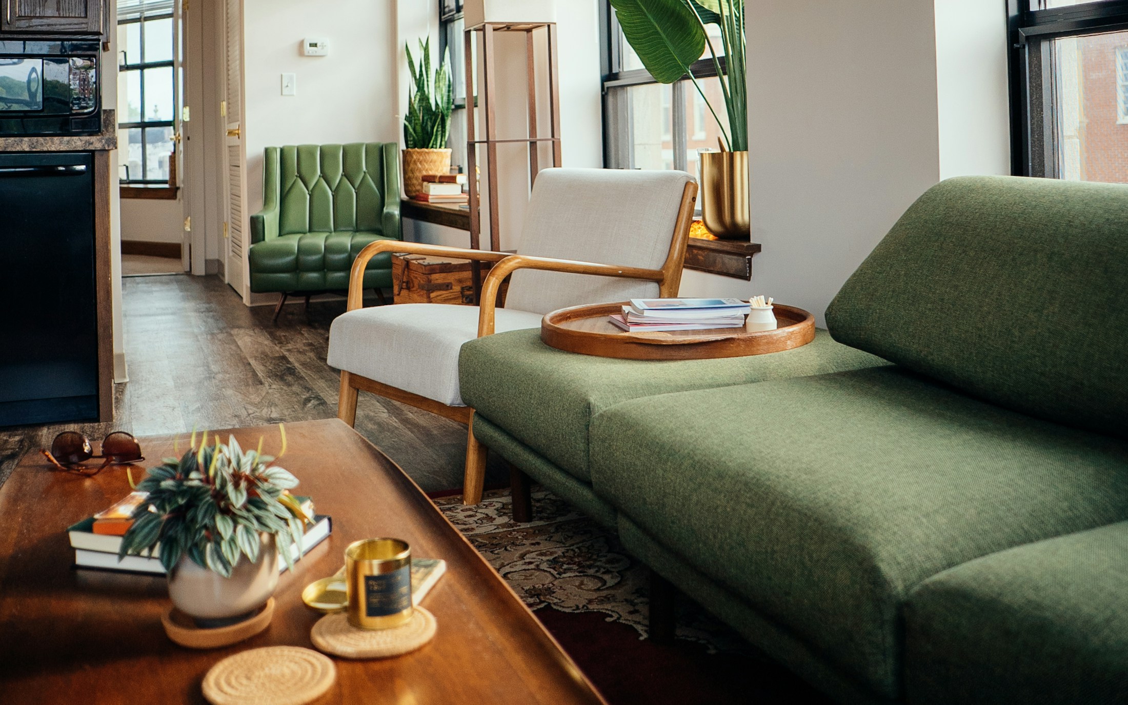 Daylight in a modern condo living room with comfortable seating and wood furniture